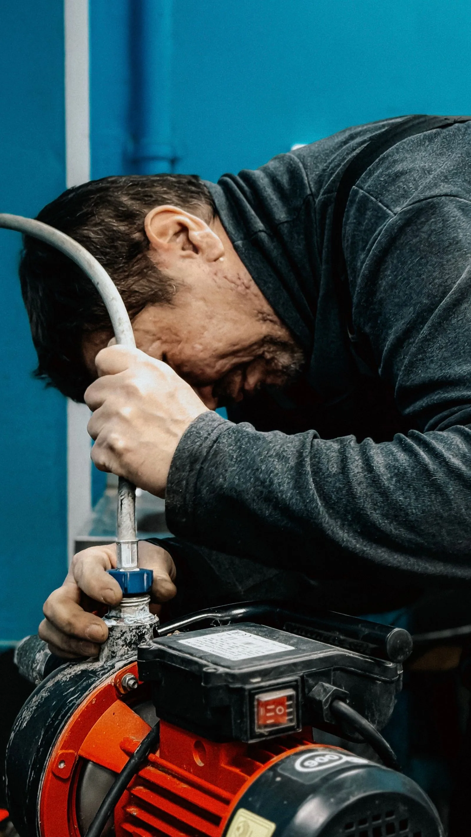 Technician adjusting a water pump indoors
